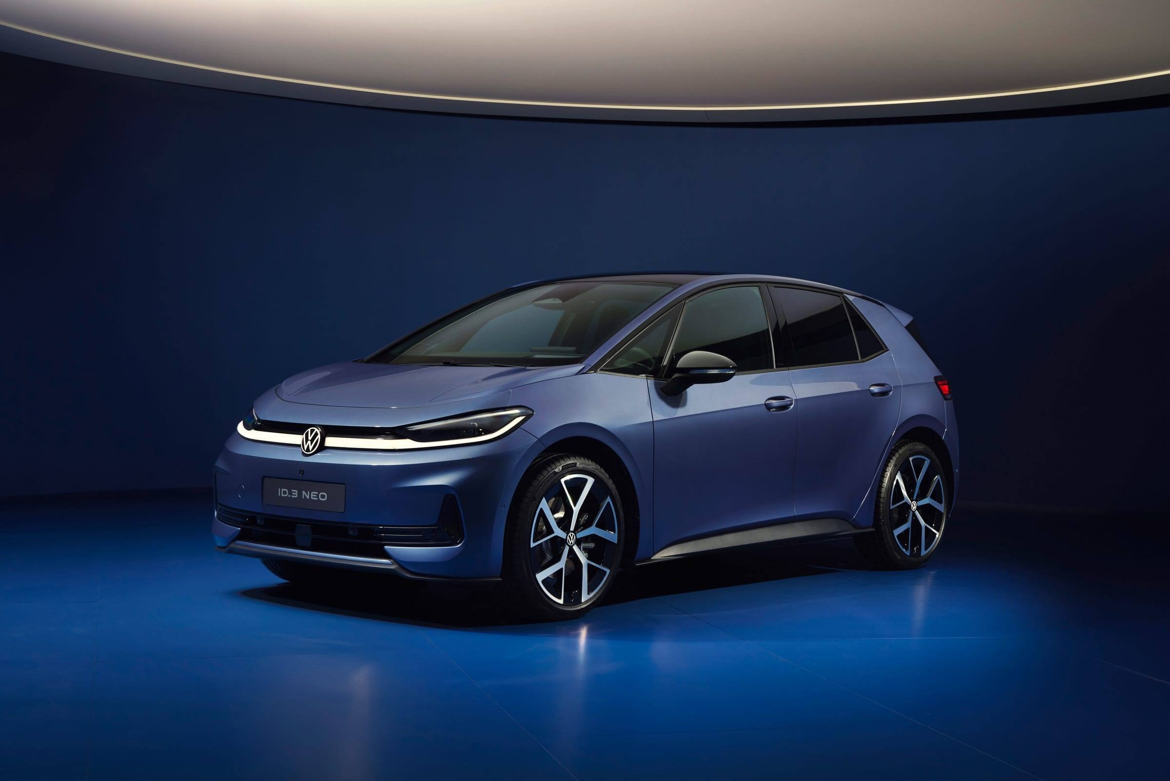 Blue Volkswagen ID.3 Neo, front three-quarter view, in a dark blue studio