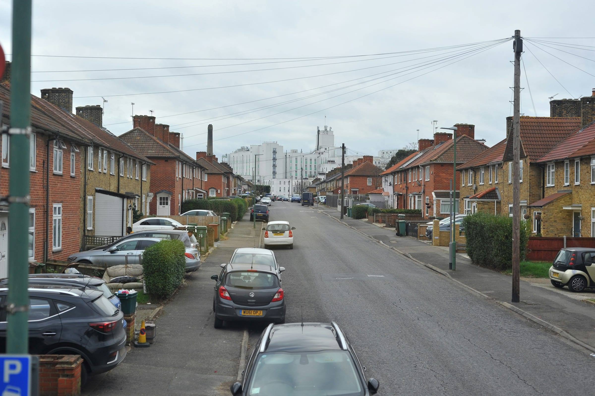 Cars parked along the kerb of a residential street in Sutton, south London