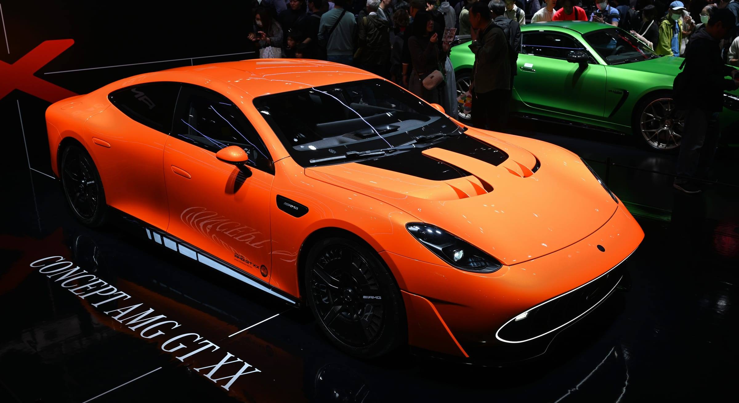 The orange Mercedes-AMG Concept GT XX electric show car on a motor show stand
