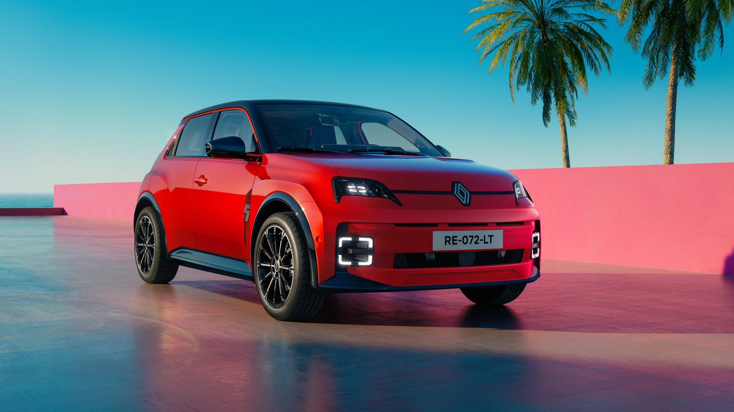 Red Renault 5 E-Tech electric, front three-quarter view, on a waterside terrace with palm trees