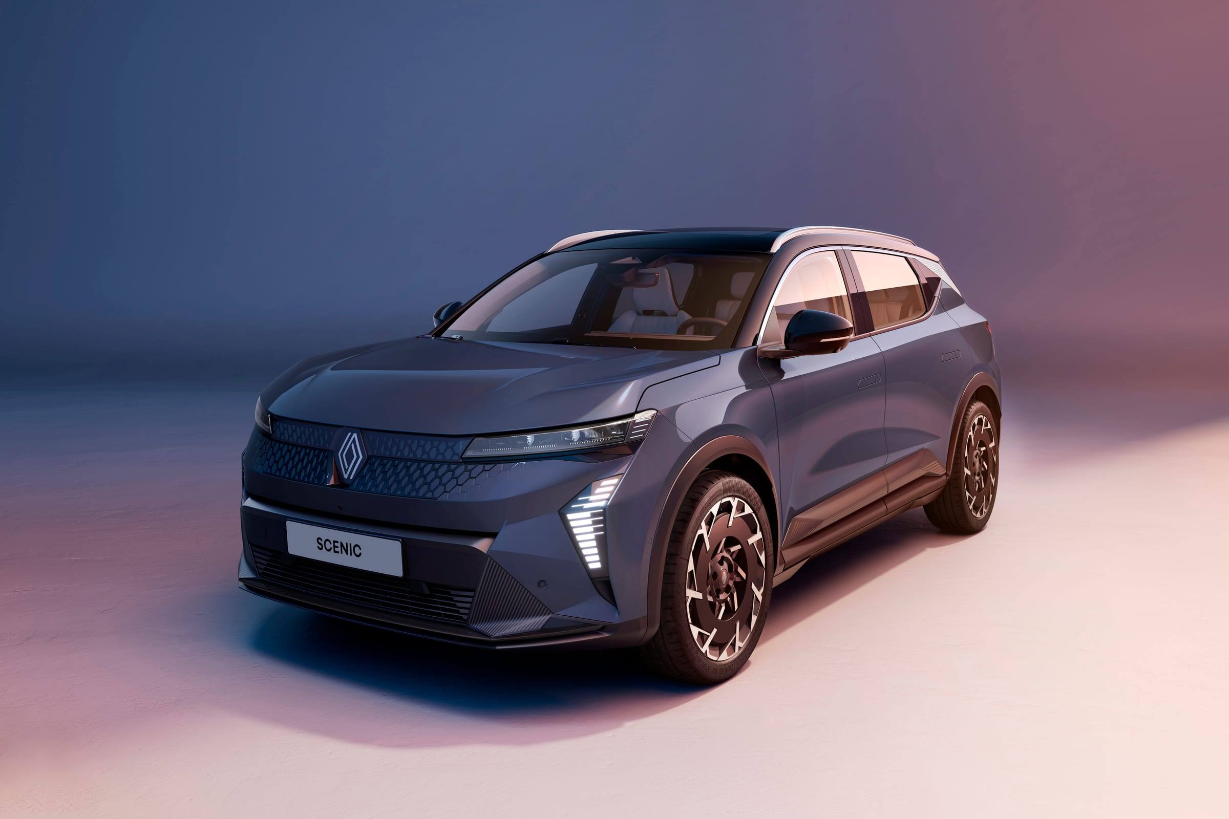 Blue-grey Renault Scenic E-Tech electric, front three-quarter view, in a studio