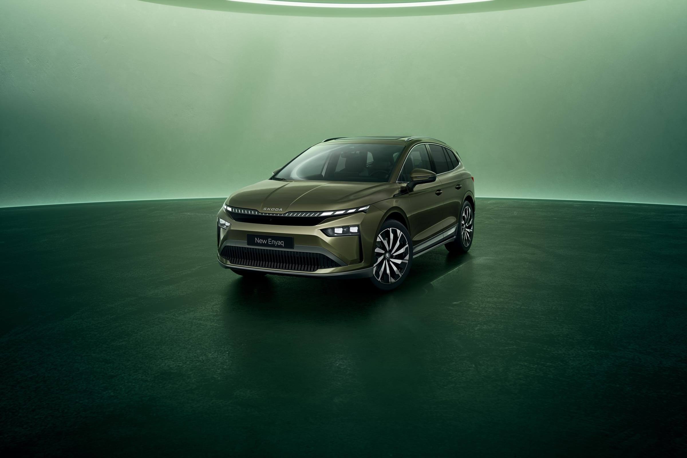 Olive green facelifted Škoda Enyaq, front three-quarter view, in a green studio
