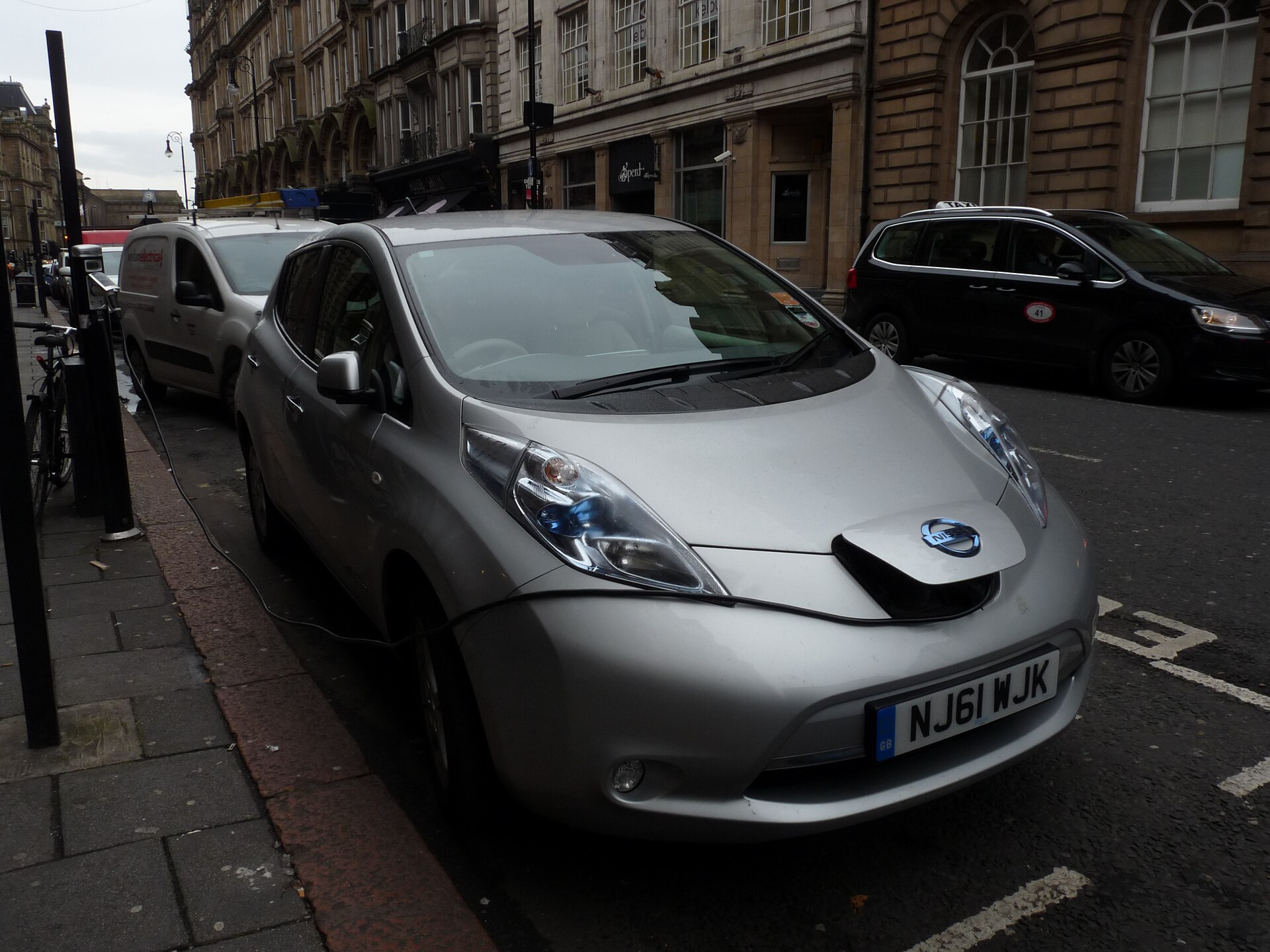 An electric car connected to an on-street charging point