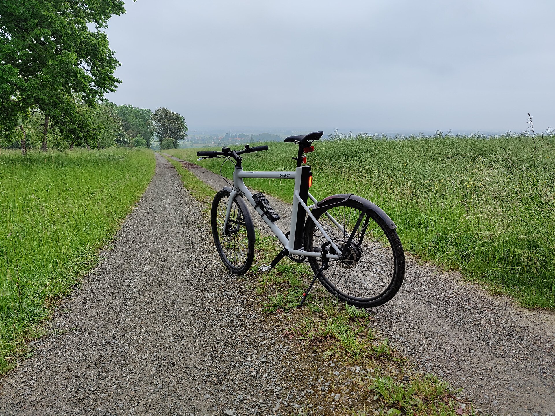 A black urban electric bicycle photographed outdoors